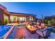 Backyard at night with fire pit, spa, and seating at 9771 E Roadrunner Dr, Scottsdale, AZ 85262