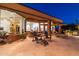 Large patio with seating area and views of the outdoor kitchen and dining area at 9771 E Roadrunner Dr, Scottsdale, AZ 85262