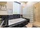 Spa-like bathroom with a soaking tub and glass block shower at 9771 E Roadrunner Dr, Scottsdale, AZ 85262