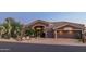 Two-story home with desert landscaping and a three-car garage at 9771 E Roadrunner Dr, Scottsdale, AZ 85262