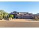 Beautiful home with desert landscaping and a three-car garage at 9771 E Roadrunner Dr, Scottsdale, AZ 85262