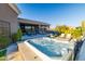 Relax in the outdoor hot tub, surrounded by desert landscaping at 9771 E Roadrunner Dr, Scottsdale, AZ 85262