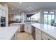 Modern kitchen with white cabinets, stainless steel appliances and a large island at 9771 E Roadrunner Dr, Scottsdale, AZ 85262