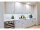 Modern kitchen with white cabinets, wine cooler and coffee bar at 9771 E Roadrunner Dr, Scottsdale, AZ 85262