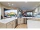 Modern kitchen with large island, stainless steel appliances, and Gathering room view at 9771 E Roadrunner Dr, Scottsdale, AZ 85262