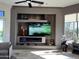 Elegant living room featuring a built-in entertainment center with a fireplace and large TV at 9771 E Roadrunner Dr, Scottsdale, AZ 85262