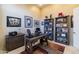 Home office with a large desk and built-in shelving at 9771 E Roadrunner Dr, Scottsdale, AZ 85262