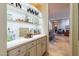 Stylish wet bar with quartz countertops and ample storage at 9771 E Roadrunner Dr, Scottsdale, AZ 85262