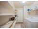 Laundry room with washer, dryer, and shelving at 11526 W Scotts Dr, El Mirage, AZ 85335