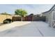 Large backyard with a paved patio area and gated access to the rear of the property at 1228 N 102Nd St, Mesa, AZ 85207