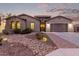 Single-story home with desert landscaping and a three-car garage at 1228 N 102Nd St, Mesa, AZ 85207