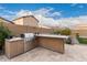 Outdoor kitchen with built-in grill and stone countertops at 1228 N 102Nd St, Mesa, AZ 85207