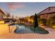 Relaxing pool at dusk with landscape lighting and patio umbrella at 1228 N 102Nd St, Mesa, AZ 85207