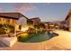 Night view of a kidney-shaped pool with a waterfall and basketball hoop at 1228 N 102Nd St, Mesa, AZ 85207