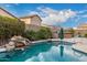 Inviting backyard pool with a waterfall feature and spacious patio at 1228 N 102Nd St, Mesa, AZ 85207