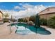 Large kidney-shaped pool with a waterfall and patio umbrella at 1228 N 102Nd St, Mesa, AZ 85207