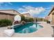 Backyard pool with a basketball hoop and rock waterfall feature at 1228 N 102Nd St, Mesa, AZ 85207