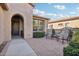 Inviting brick courtyard with two chairs and a small table at 12951 W Andrew Ln, Peoria, AZ 85383