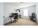 Gaming room with a large window, two stylish gaming chairs and a modern wall-mounted television at 14850 W Laurel Ln, Surprise, AZ 85379