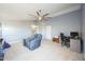 Living room with ceiling fan, workstation, and a comfortable recliner, perfect for relaxation at 14850 W Laurel Ln, Surprise, AZ 85379