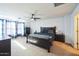 Well-lit main bedroom features a ceiling fan, soft carpet and ample natural light at 14850 W Laurel Ln, Surprise, AZ 85379