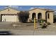 Charming home featuring desert landscaping, a two-car garage, and stylish architectural details at 17346 W Alder Ln, Surprise, AZ 85387