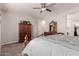 Bedroom with a wooden dresser and ceiling fan at 19122 W Solano Dr, Litchfield Park, AZ 85340