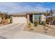 Single-story home with a two-car garage and desert landscaping at 19122 W Solano Dr, Litchfield Park, AZ 85340