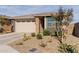 Single-story house with a two-car garage, landscaping, and neutral color palette at 19122 W Solano Dr, Litchfield Park, AZ 85340