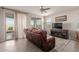 Relaxing living room with leather furniture and sliding glass door access to patio at 19122 W Solano Dr, Litchfield Park, AZ 85340