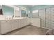 Elegant bathroom with double vanity and a patterned shower at 19544 W Lincoln St, Buckeye, AZ 85326