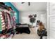 Organized bedroom featuring open storage racks, a bed, and a teal accent wall, providing functional living space at 19544 W Lincoln St, Buckeye, AZ 85326