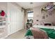 Stylish bedroom with a large closet, pink walls, and charming decorative touches at 19544 W Lincoln St, Buckeye, AZ 85326