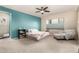 Comfortable bedroom featuring bright turquoise accent walls, neutral carpet, and a serene atmosphere at 19544 W Lincoln St, Buckeye, AZ 85326