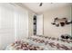 Well-lit bedroom boasts a large closet, neutral walls, and a colorful patterned bedspread for a comfortable atmosphere at 19544 W Lincoln St, Buckeye, AZ 85326