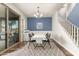Dining area with table, chandelier, and a sliding door to the patio, adjacent to the stairway at 19544 W Lincoln St, Buckeye, AZ 85326
