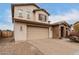 Angle shot of the front exterior, brick driveway, and two-car garage at 19544 W Lincoln St, Buckeye, AZ 85326