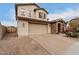 View of the home's front exterior with brick driveway and a two-car garage at 19544 W Lincoln St, Buckeye, AZ 85326