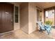 Front porch with two teal chairs and a dark brown door at 19544 W Lincoln St, Buckeye, AZ 85326