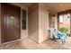 Inviting front porch with stylish tile flooring, two comfortable chairs, and a welcoming doormat at 19544 W Lincoln St, Buckeye, AZ 85326