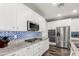 White cabinets, granite countertops, and stainless steel appliances in the kitchen at 19544 W Lincoln St, Buckeye, AZ 85326