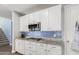 White kitchen with granite countertops and stainless steel appliances at 19544 W Lincoln St, Buckeye, AZ 85326