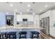 Island kitchen with granite countertops and blue-toned pendant lights at 19544 W Lincoln St, Buckeye, AZ 85326