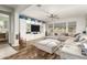 Spacious living room with hardwood floors, a ceiling fan, and a large entertainment center at 19544 W Lincoln St, Buckeye, AZ 85326