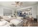 Cozy living room seamlessly connects to kitchen, featuring a plush sectional and modern finishes at 19544 W Lincoln St, Buckeye, AZ 85326
