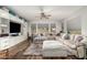 Spacious living room featuring wood floors, a large sectional sofa, and custom built-in shelving at 19544 W Lincoln St, Buckeye, AZ 85326