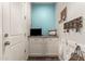 Cozy mud room featuring white cabinets, a blue accent wall, and stylish decor perfect for organization and welcomes at 19544 W Lincoln St, Buckeye, AZ 85326