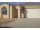 Newly built home with a two-car garage and neutral exterior at 20 W Whyman Ave, Avondale, AZ 85323