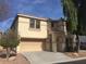 Tan two-story house with two-car garage and mature trees in front at 2636 S Sailors Way, Gilbert, AZ 85295