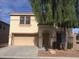 Two-story house with tan exterior, arched entryway, and attached garage at 2636 S Sailors Way, Gilbert, AZ 85295